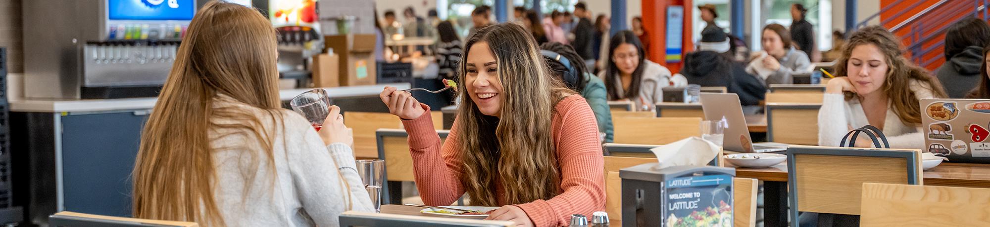 Students enjoying a conversation while eating.